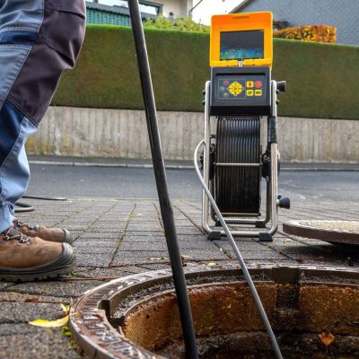 A drain cleaning company checks a blocked drain with a camera before flushing it out